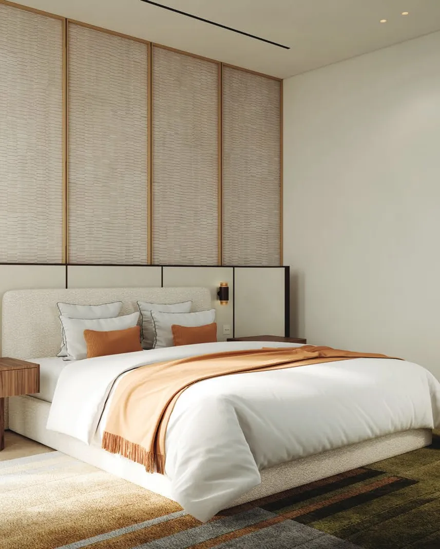 Calm bedroom in soft neutral tones with textured headboard wall