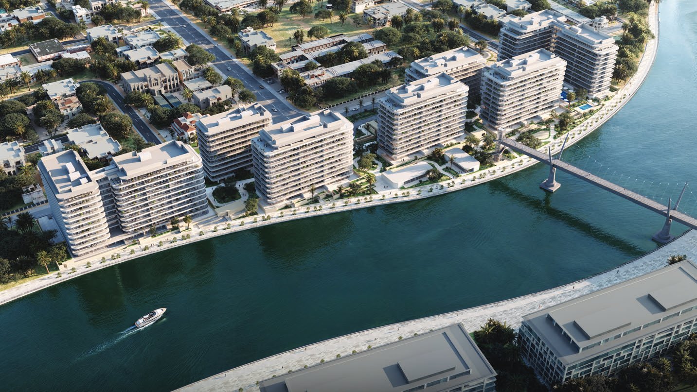 Aerial view of seven buildings along the canal and footbridge